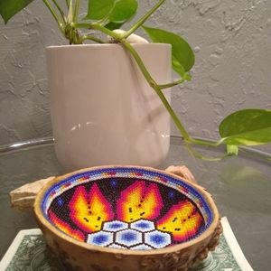 This is a wooden bowl with beads